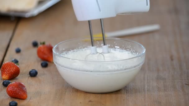 Whipping cream with a mixer. Bubbles on cream. — Stock Video