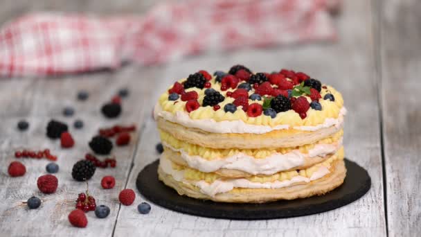 Layered cake decorated with berries and mint. — Stock Video
