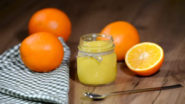Orange cream curd in glass jar. — Stock Video
