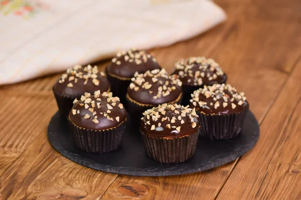 Nut-chocolate muffins covered with dark chocolate and nuts