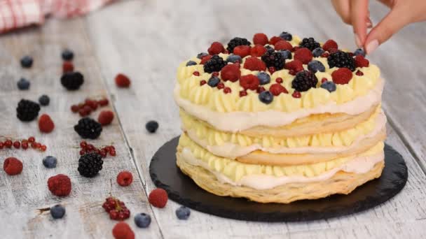 Layered cake decorated with berries and mint. — Stock Video