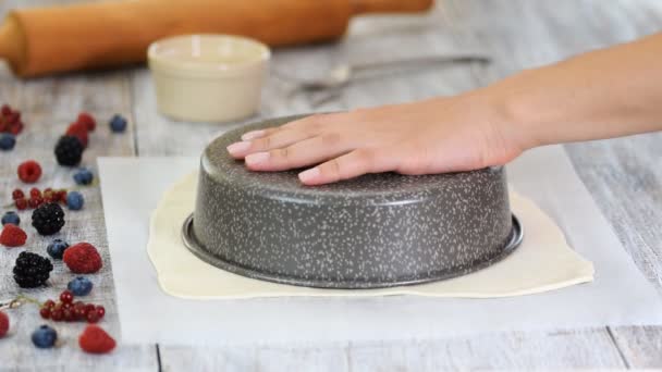 Koken snijden deeg in cirkel voor zelfgemaakte bakken. Vrouw snijden rauw deeg op het Perkamentpapier met een mes. — Stockvideo