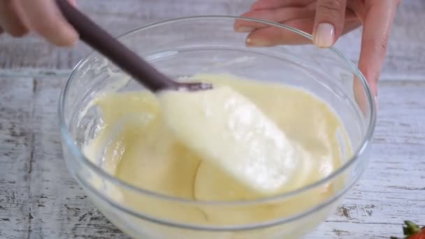 A woman stirs the batter in a mixing bowl. — Stock Video