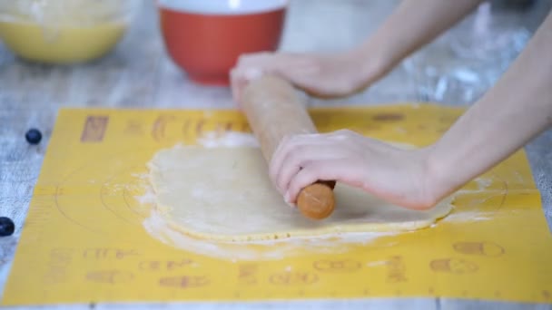 Femme dérouler la pâte sablée avec une broche à roulettes . — Video