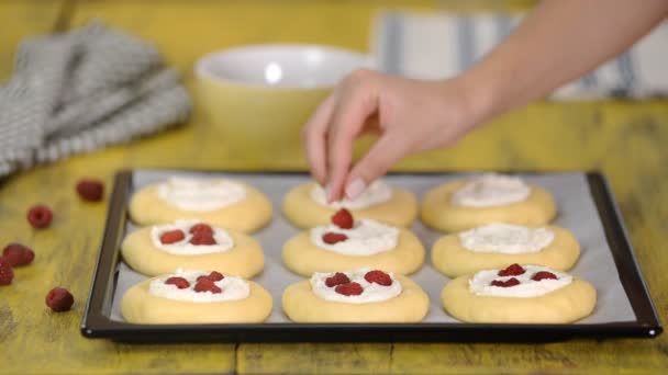La donna cucina in cucina dolci panini aperti con ricotta, lamponi e shtreyzelem. Il concetto di pasticceria fatta in casa, panini di cottura vatrushka . — Video Stock