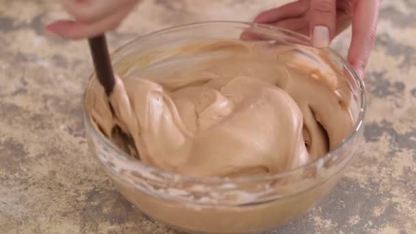 Mixing chocolate cream in glass bowl. Close-up. — Stock Video