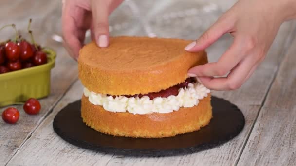 Femme faisant le gâteau cerise nue avec crème vanille. — Video