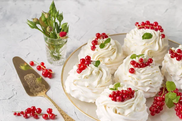 Pavlova cakes with cream and fresh summer berries. Close up of Pavlova dessert with forest fruit and mint. Food photography