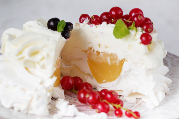 Pavlova cakes in a cut with cream and fresh summer berries. Close up of Pavlova dessert with forest fruit and mint. Food photography