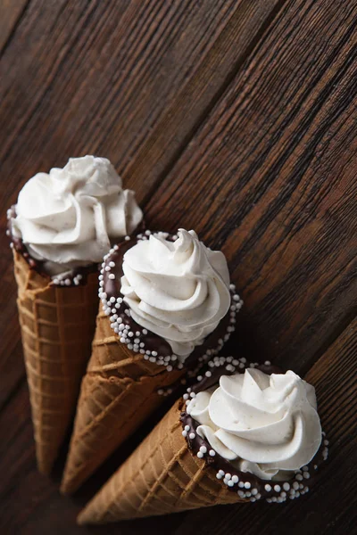 ice cream cones on wooden table. Soft ice creams or frozen custard in cones. Waffle marshmallow imitating ice cream