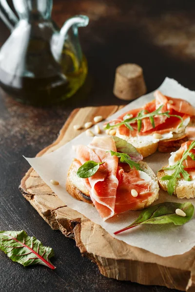 Traditional parma cured ham antipasto. Bruschetta set with Parma