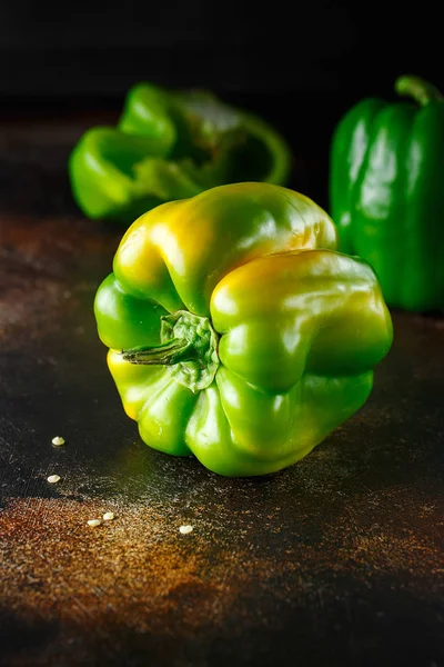 Sweet green pepper on dark background. Fresh yellow green bell p