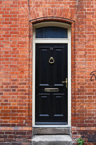 A black door in Dublin, Ireland. Arched Georgian door house fron