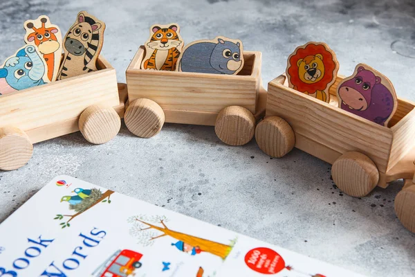 Children's wooden toys. Children wooden freight train with wagons. Natural wood construction set. Educational equipment