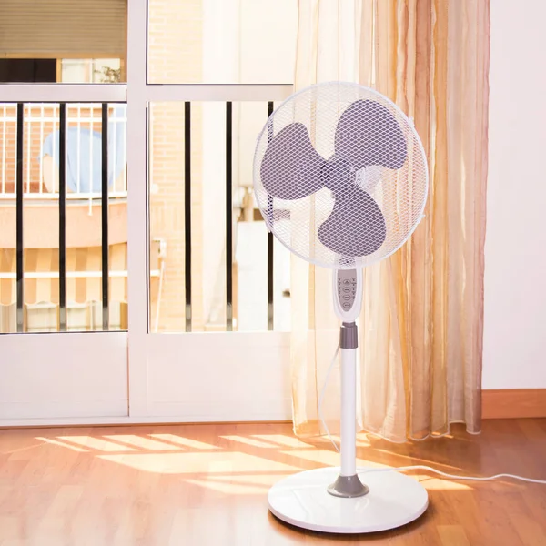 Electric fan that cools the air during a hot day at home.Photo