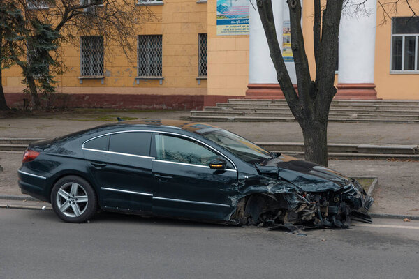 A wheel flew off a car. Close-up, details. Car wheel. Serious accident. Car on the road without a wheel. Lost control and collided with a tree