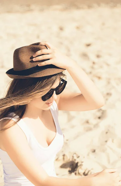 Bastante adolescente con el pelo largo y un sombrero en el sol negro de moda —  Fotos de Stock