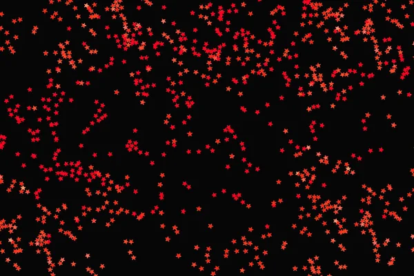 Punainen koriste tähdet mustalla pohjalla — kuvapankkivalokuva