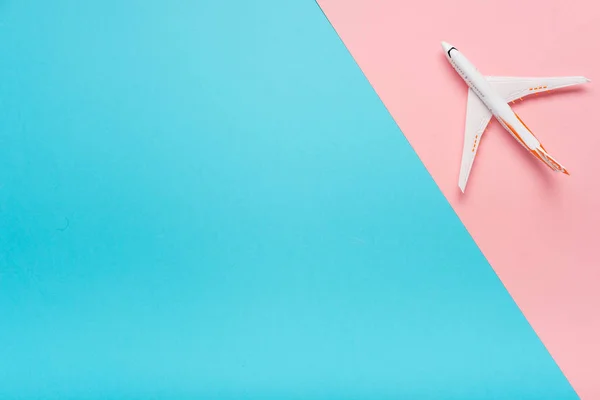 Draufsicht eines Flugzeugs auf trendigem Hintergrund. helle Sommerfarbe. Reisekonzept. — Stockfoto