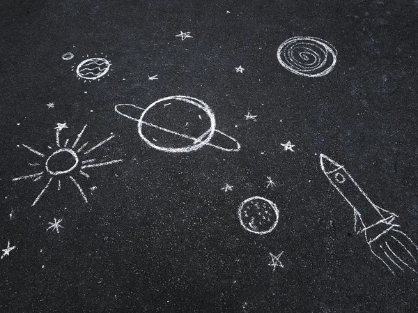 Chalk drawing. Space, planets and stars painted by children's.