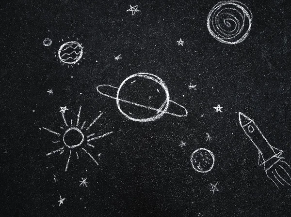 Chalk drawing. Space, planets and stars painted by children\'s.