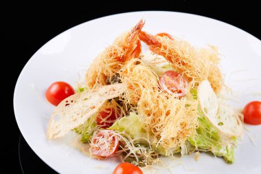 Karides, salata yaprağı, kiraz domates ve parmesan peyniri ile deniz ürünleri salatası.