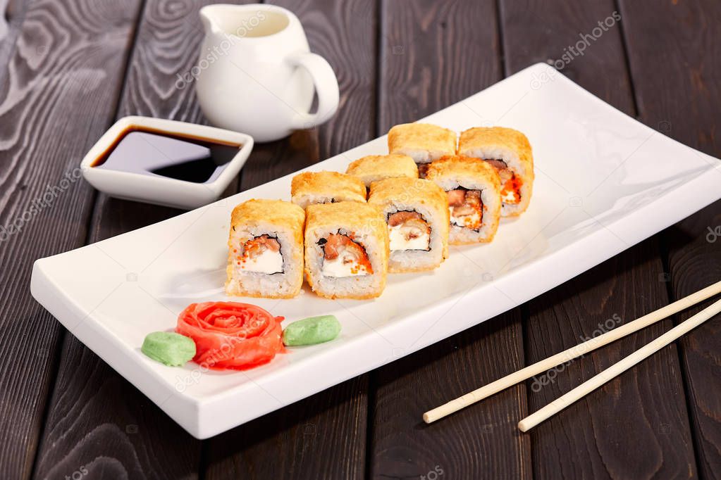 Sushi rolls on a plate with chopsticks and soy sauce. Japan cuisine