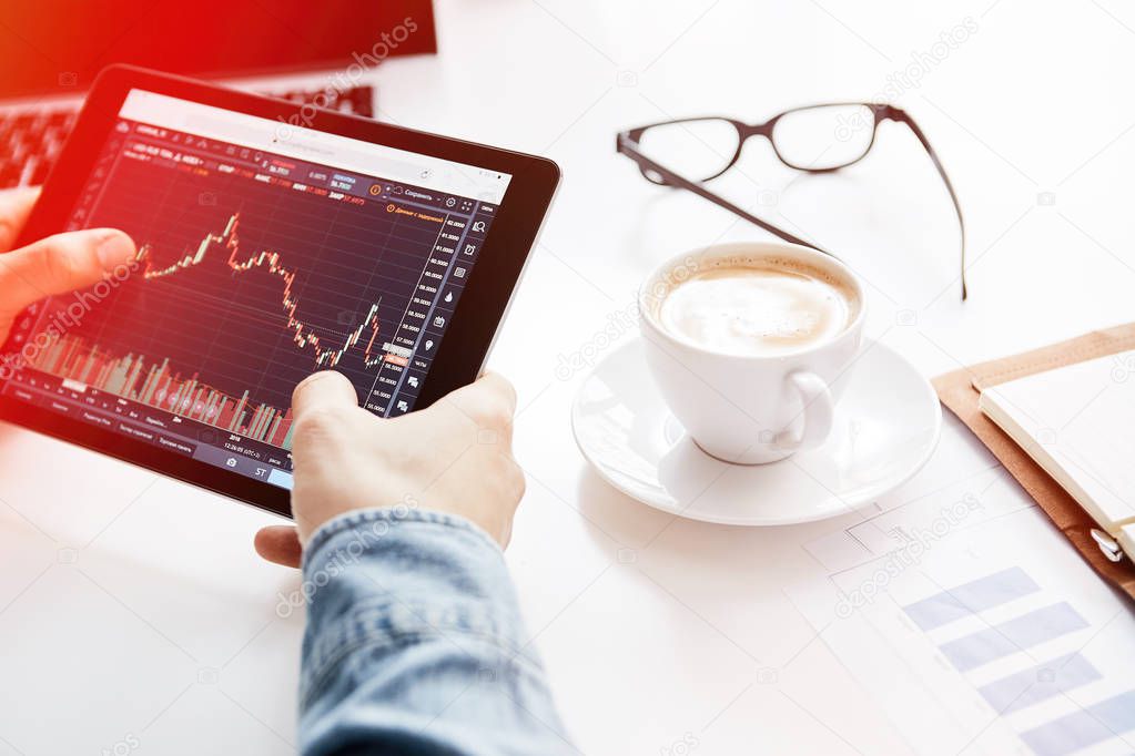 Investor watching the change of stock market on tablet. Cryptocurrency trading platform.