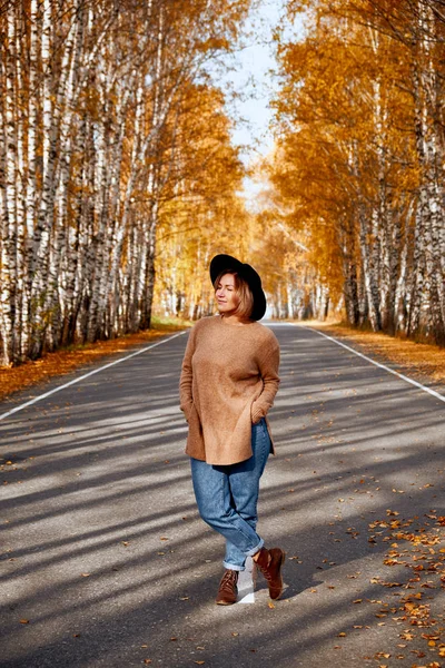 Portret van een herfst vrouw over gouden bladeren. Wandelen in het park op herfst seizoen vrouw — Stockfoto