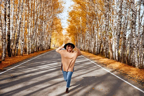 Portret van een herfst vrouw over gouden bladeren. Wandelen in het park op herfst seizoen vrouw — Stockfoto