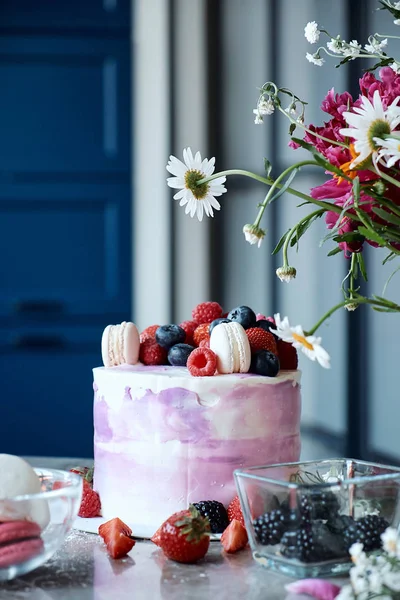 Holiday cake. Sweet desserts with berries and macarons. Cake from the fruit. Delicious sponge cake.