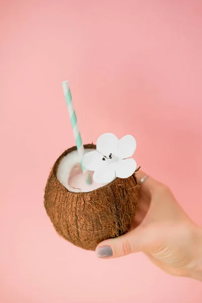 Refreshing summer drinks. Coconut drink on pastel pink background. Trendy summer color.
