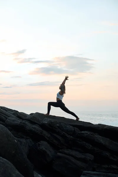 Woman Practicing Yoga in the Nature. Meditating Outdoors. Landscape background