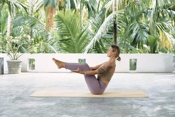 Premium Photo  Woman practicing advanced yoga on organic mat series of yoga  poses tropical background