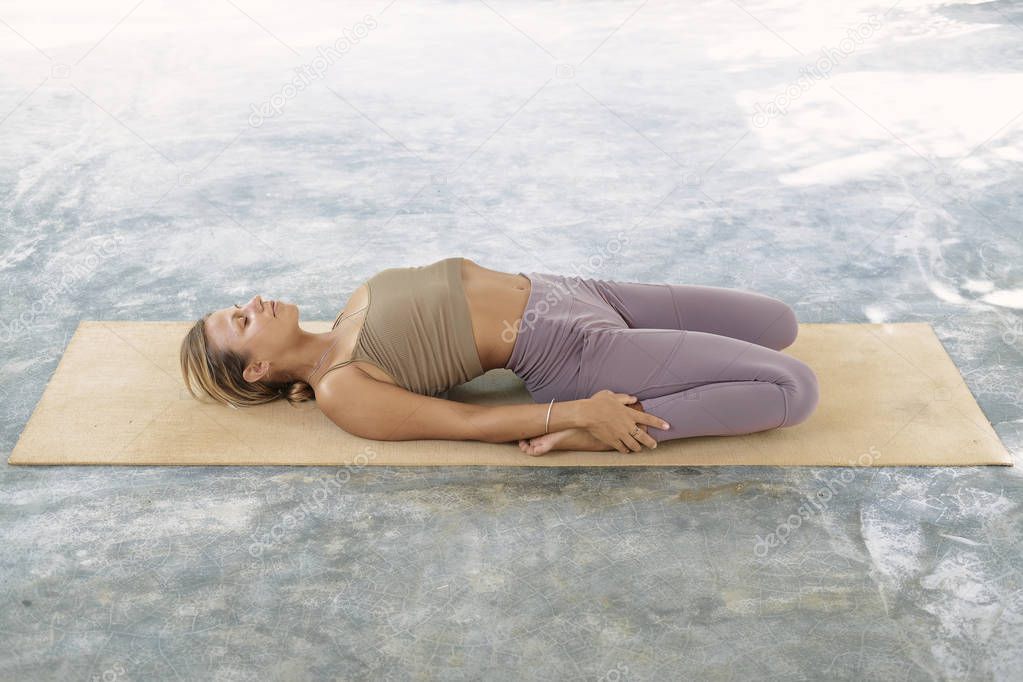 Woman Practicing Advanced Yoga on Organic Mat. Series of Yoga Poses. Tropical background