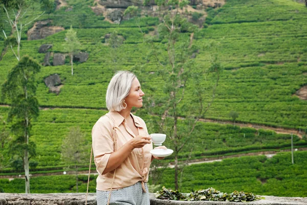 Woman with Drink Cup on Plantation Background