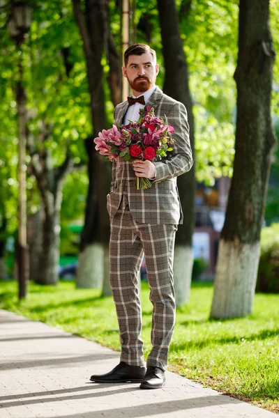 Man Clothed Stylish Suit Holding Bouquet of Flower