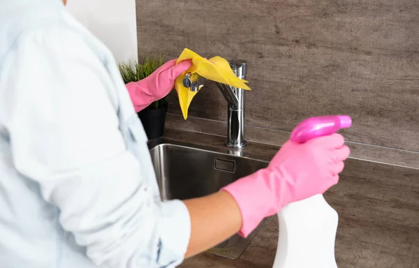 Woman doing Cleaning Kitchen. Washing a kitchen with a yellow Sponge and Detergent . House cleaning