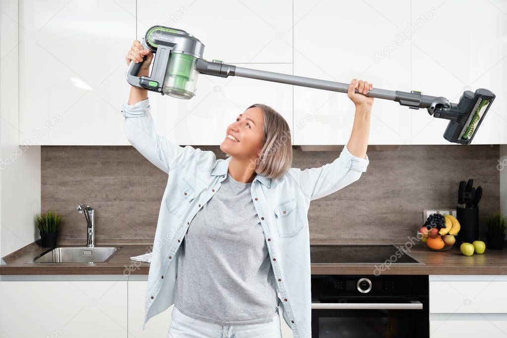 Young Woman Vacuuming the Floor. Vacuuming and Cleaning the House