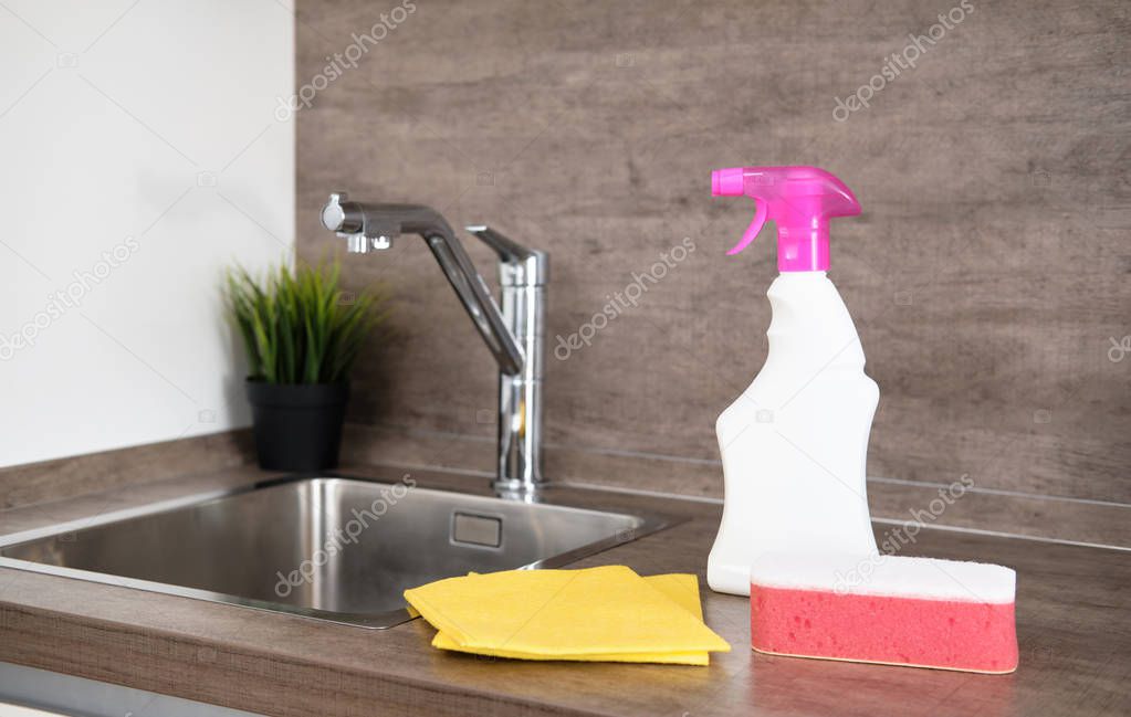 Detergents and cleaning accessories on kitchen. Cleaning and Washing Kitchen. Cleaning service concept