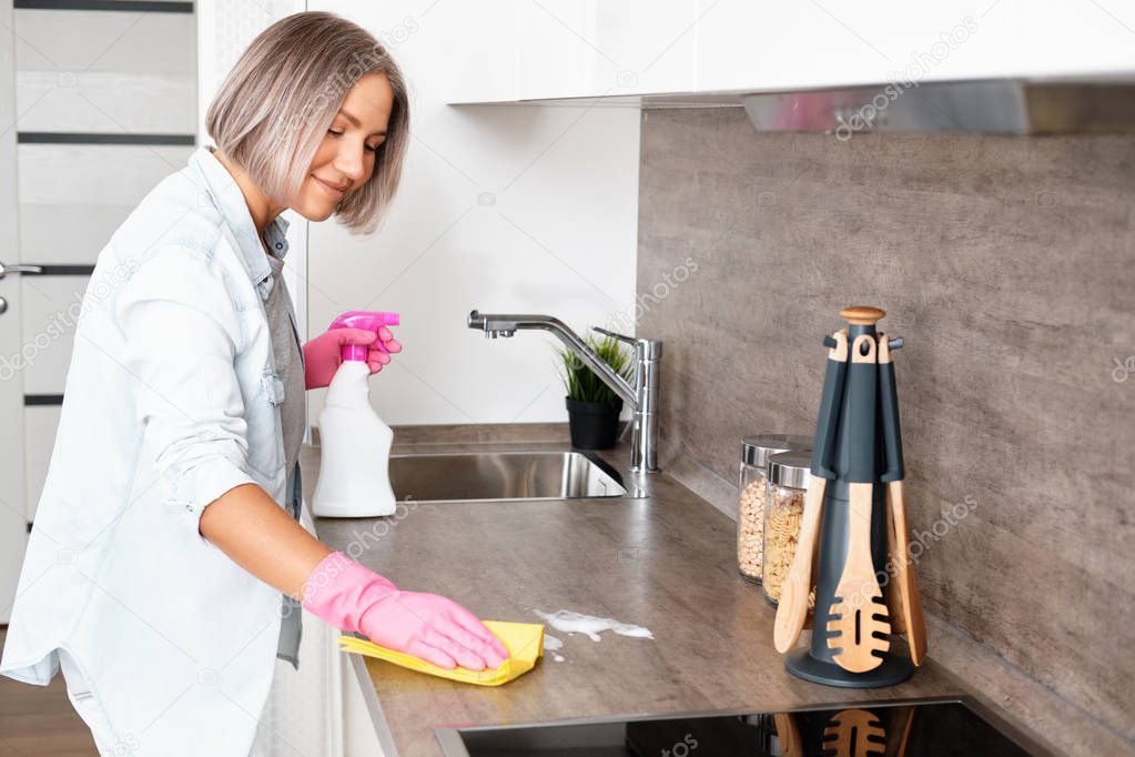 Woman doing Cleaning Kitchen. Washing a kitchen with a yellow Sponge and Detergent. House cleaning