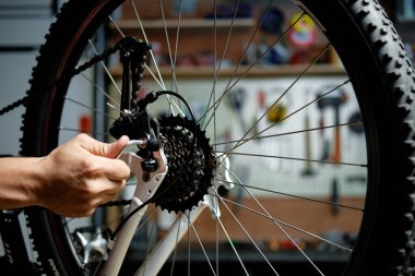 Man repairing a bicycle. Bicycle mechanic working clipart