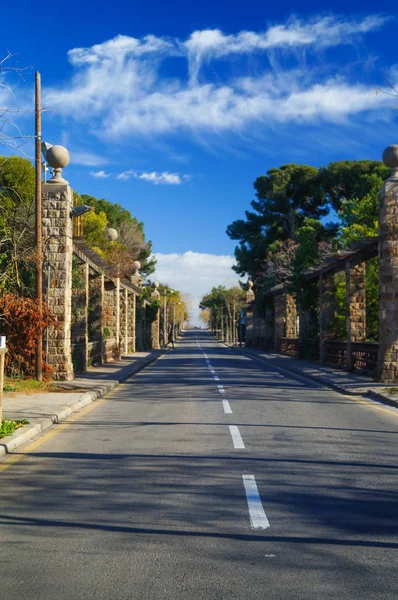 asfalt yol yeşil alan ve bulutların üstünde mavi gökyüzü ile