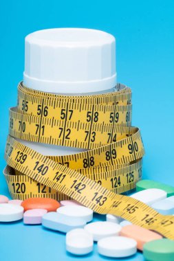 Mezura ve hap mavi bir arka plan üzerinde