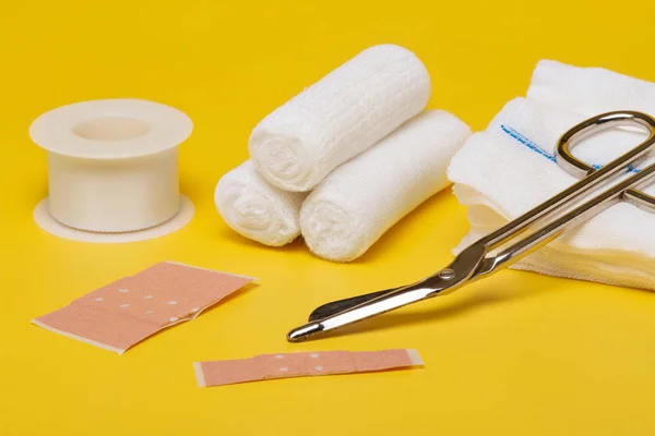 Plasters Bandages Scissors Syringe Yellow Background — Stock Photo, Image