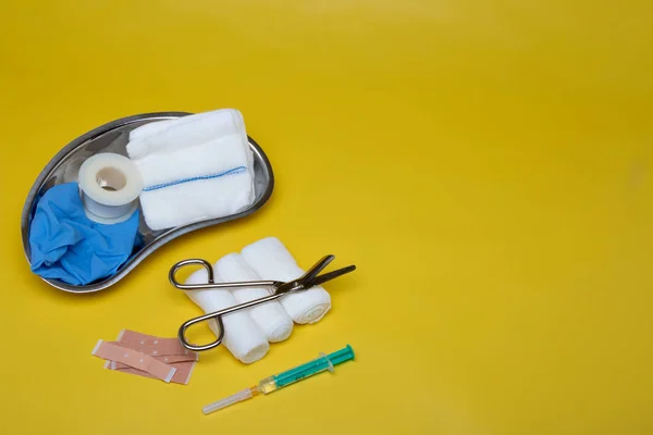 Plasters Bandages Scissors Syringe Yellow Background — Stock Photo, Image