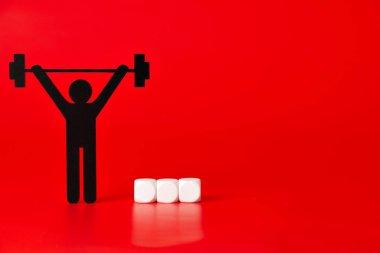 Siyah ağırlık çalışan piktogram kırmızı zemin üzerine beyaz etiketlenmemiş küpleriyle