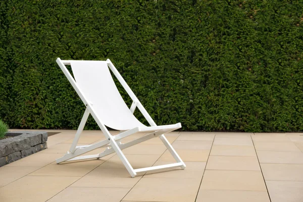 White deck chair on a stone terrace