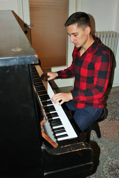 Man play on his piano in his home