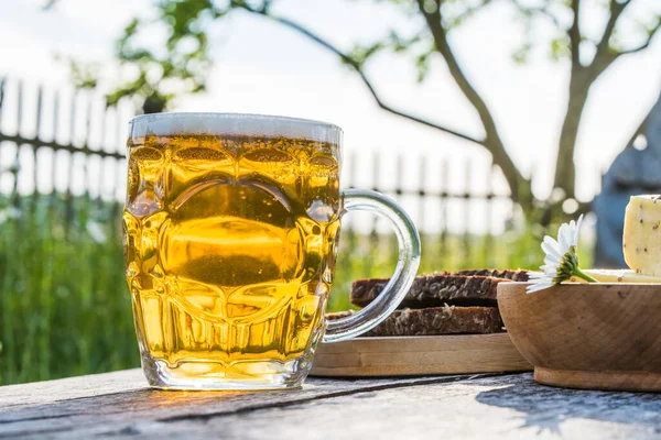 Glass of light beer with cheese and rye bread. Preparing Ligo festival. Riga. Latvia